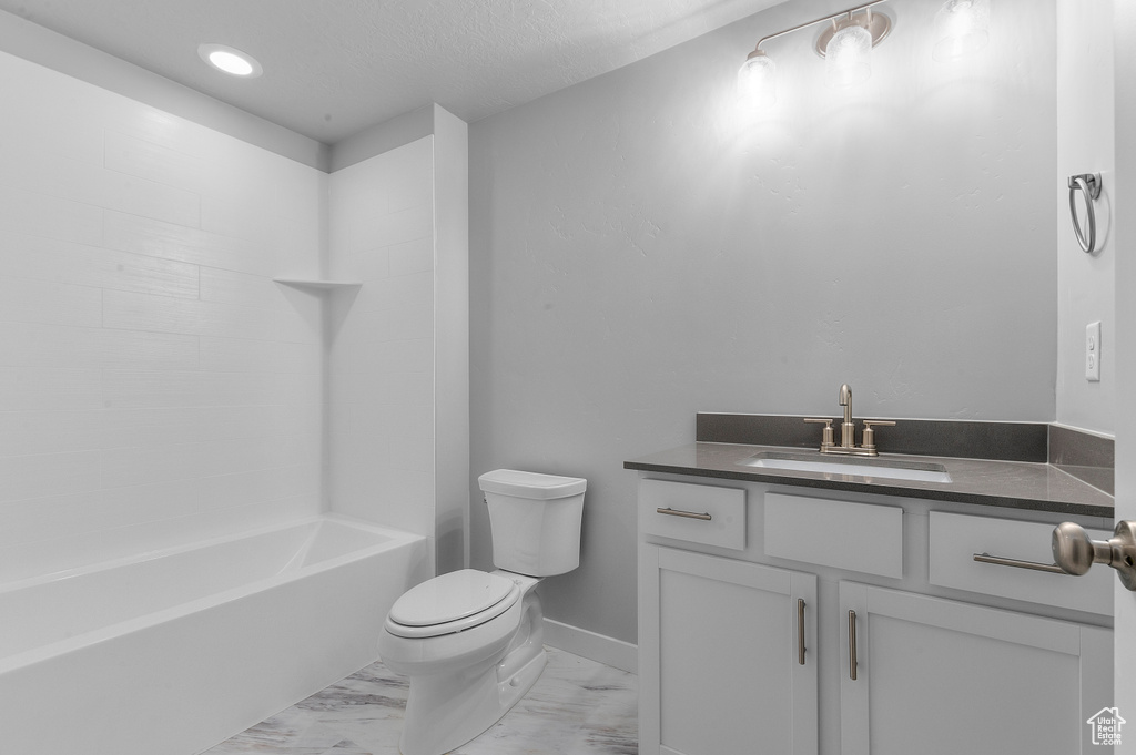 Full bath with shower / bath combination, vanity, baseboards, toilet, and marble finish floor