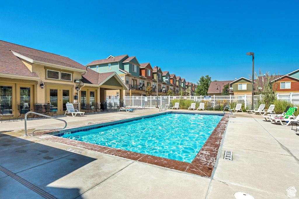 Pool featuring fence, a patio, french doors, and a residential view