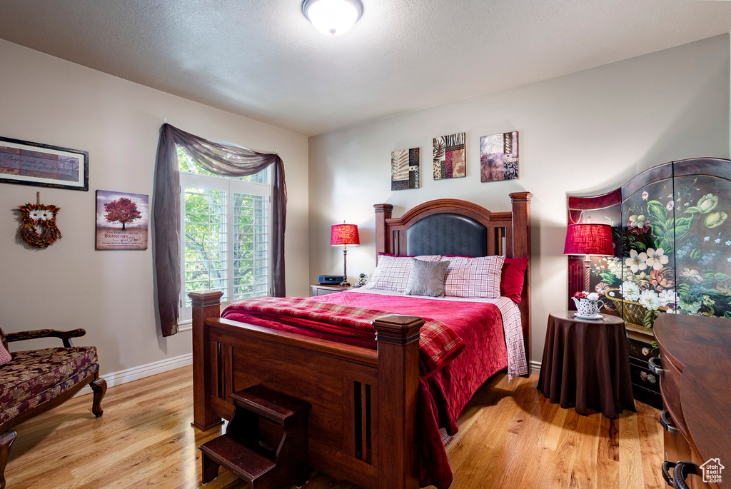 Bedroom with baseboards and light wood-style flooring