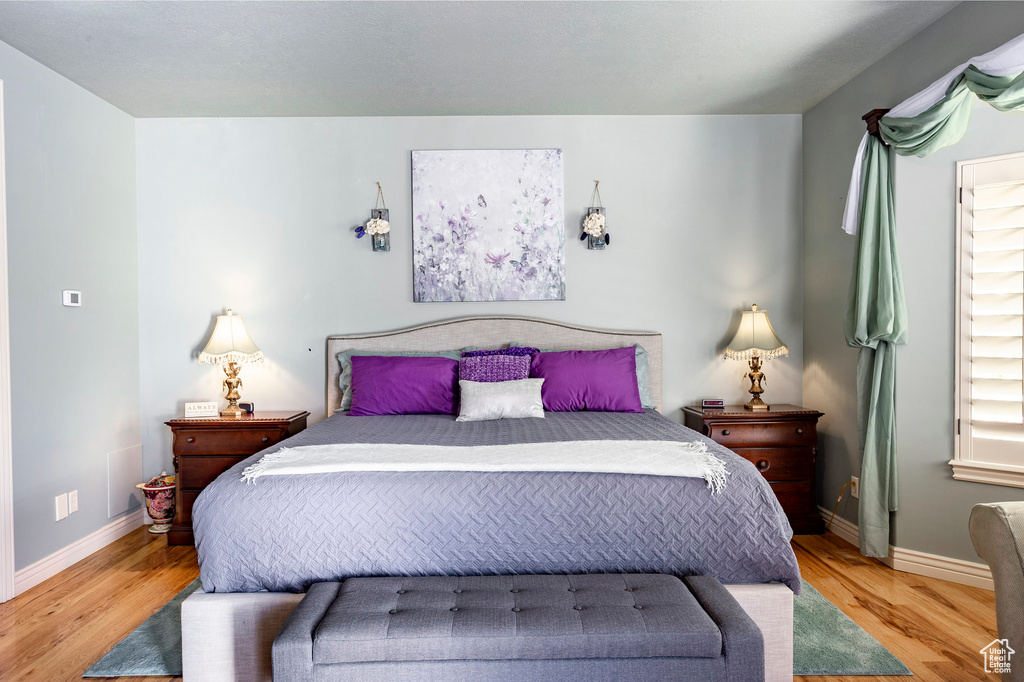 Bedroom featuring baseboards and wood finished floors