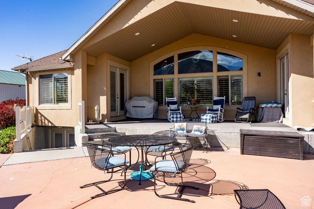 View of patio featuring french doors and outdoor dining space