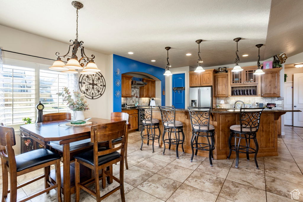Dining space with an inviting chandelier and recessed lighting