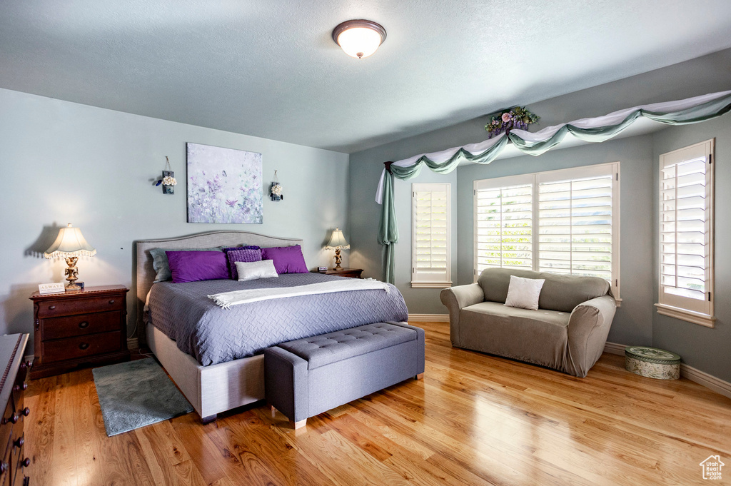 Bedroom featuring light wood-style floors and baseboards