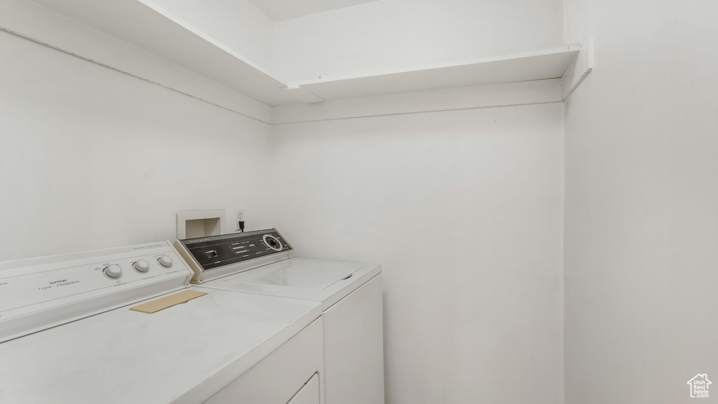 Clothes washing area featuring laundry area and washer and clothes dryer