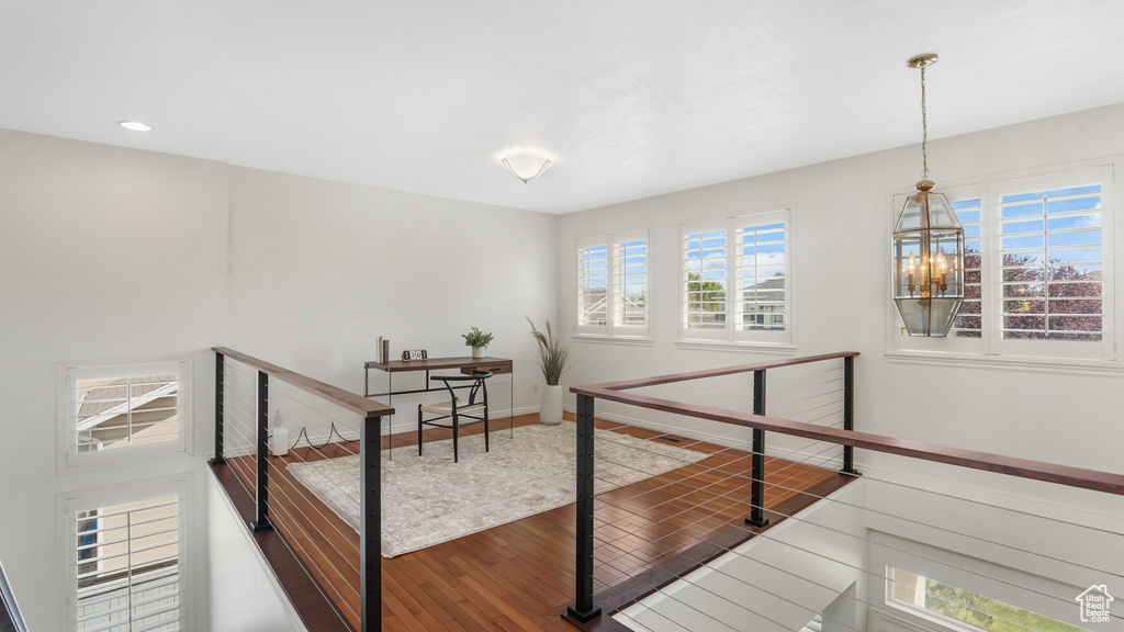 Corridor featuring recessed lighting, baseboards, an upstairs landing, and wood finished floors