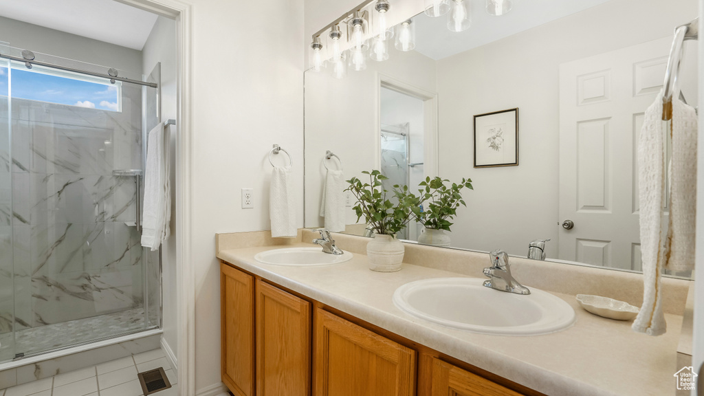 Bathroom featuring a sink and a marble finish shower