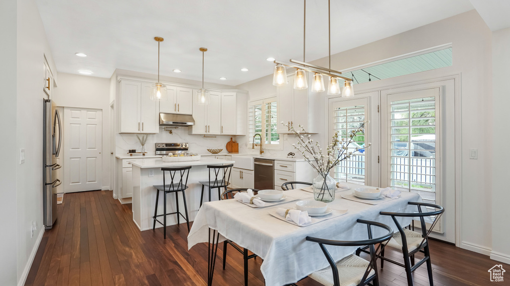 Dining space with recessed lighting, baseboards, and dark wood finished floors