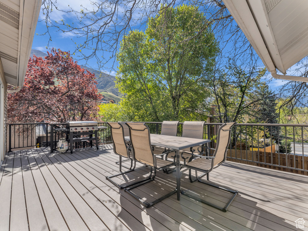 Wooden terrace with a mountain view and outdoor dining area