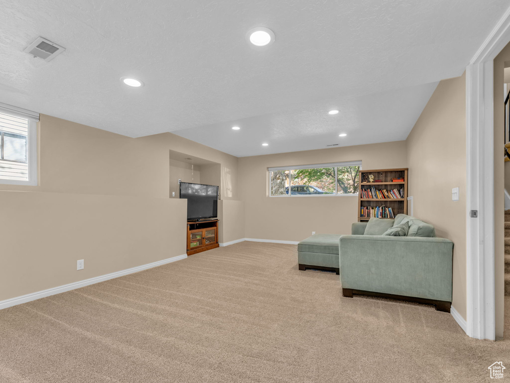 Living room with carpet floors, recessed lighting, and baseboards
