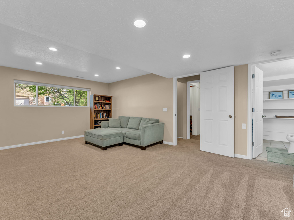Living area featuring baseboards, carpet, and recessed lighting