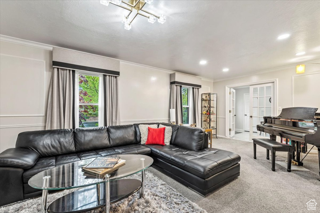 Carpeted living area featuring recessed lighting and ornamental molding