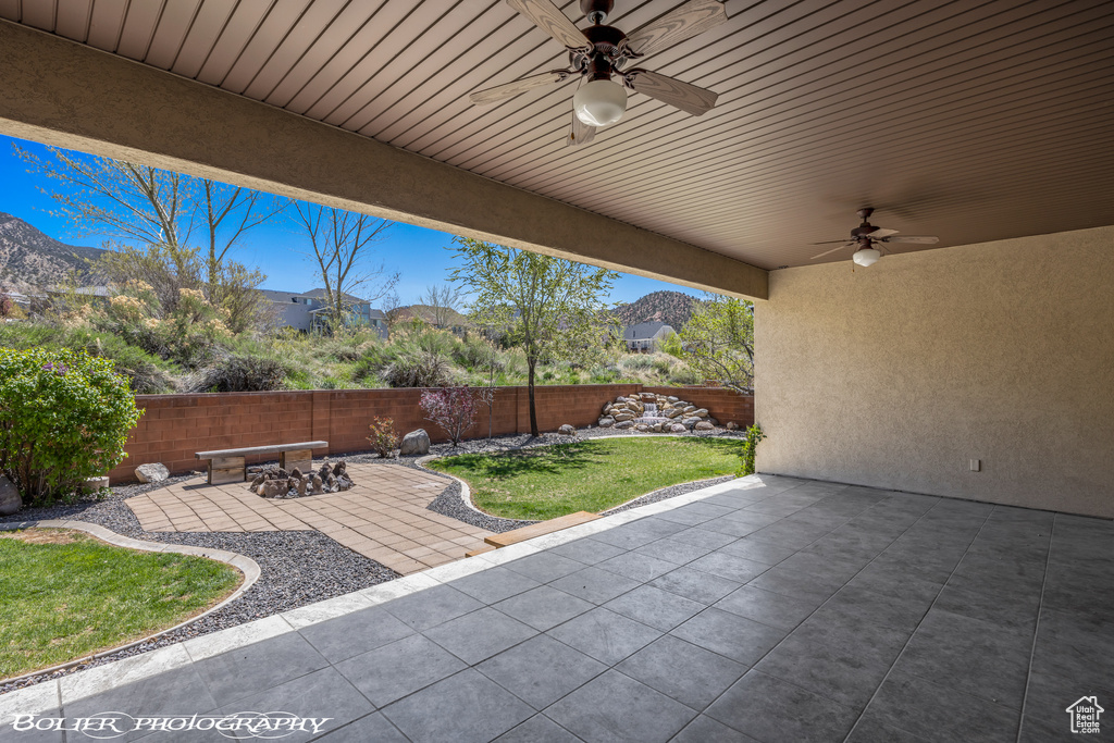 View of patio featuring a fenced backyard and a ceiling fan