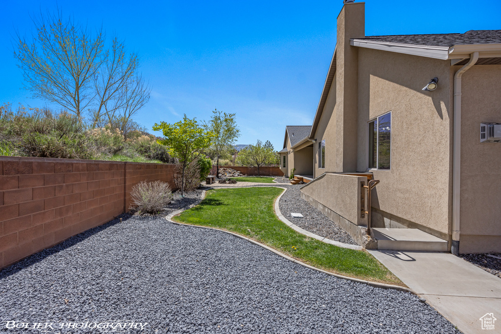 View of yard with a fenced backyard and a patio