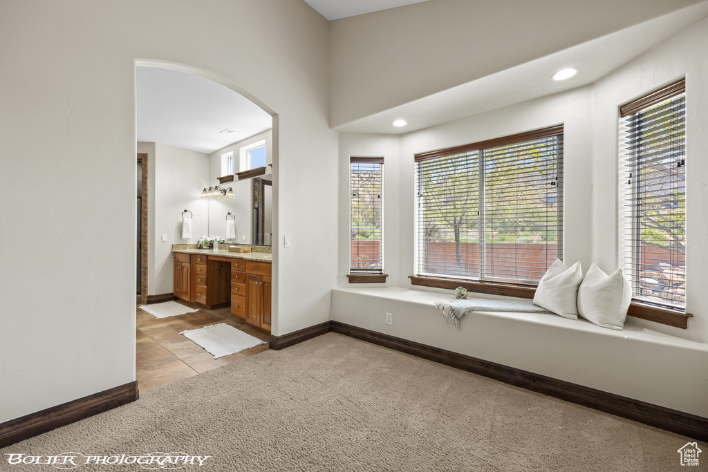 Bathroom with baseboards, recessed lighting, and vanity