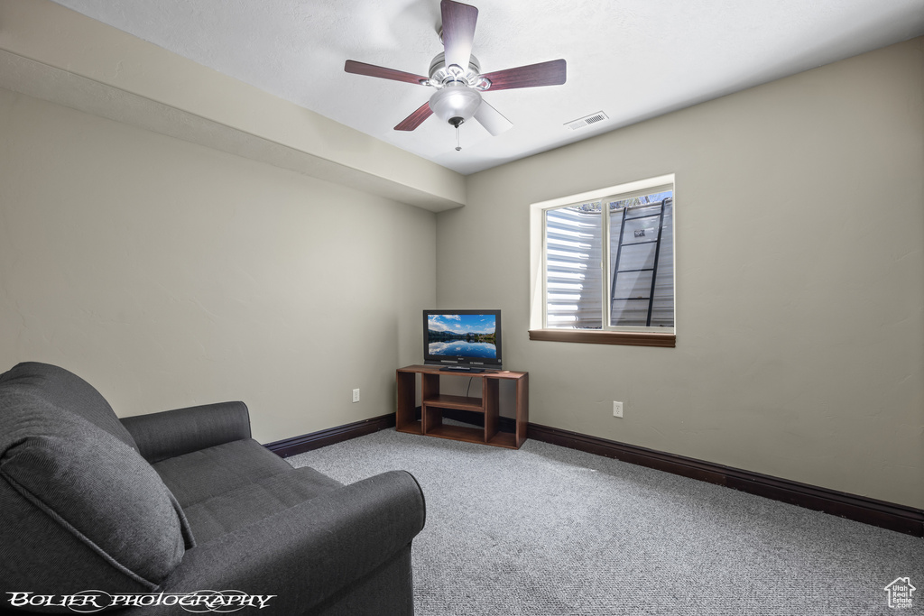 Living room featuring visible vents, carpet, ceiling fan, and baseboards