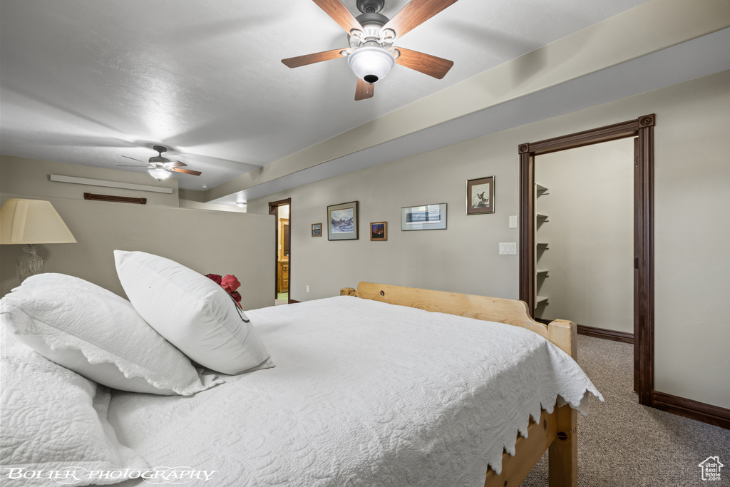 Bedroom with carpet floors, baseboards, and a ceiling fan