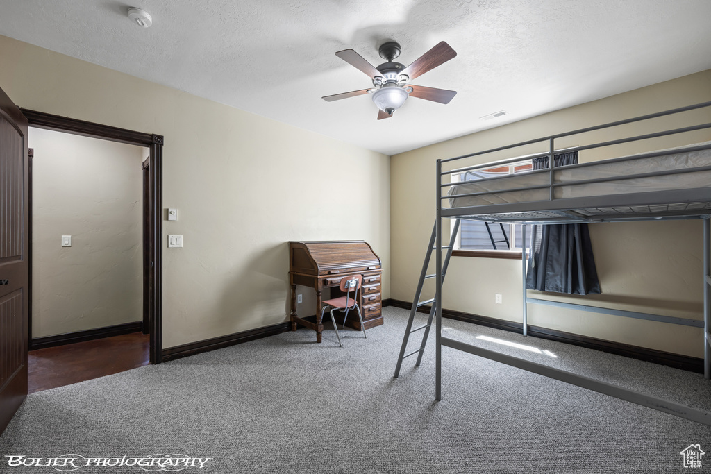 Carpeted bedroom featuring baseboards, a ceiling fan, a textured ceiling, and visible vents
