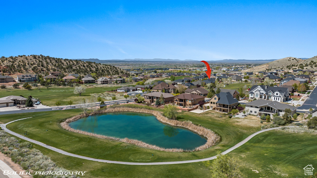 Birds eye view of property featuring a water and mountain view and a residential view