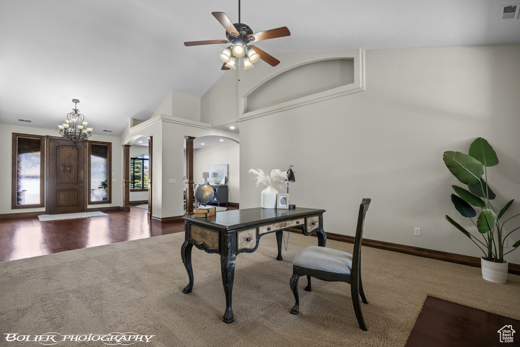 Office with carpet floors, ceiling fan with notable chandelier, baseboards, ornate columns, and visible vents
