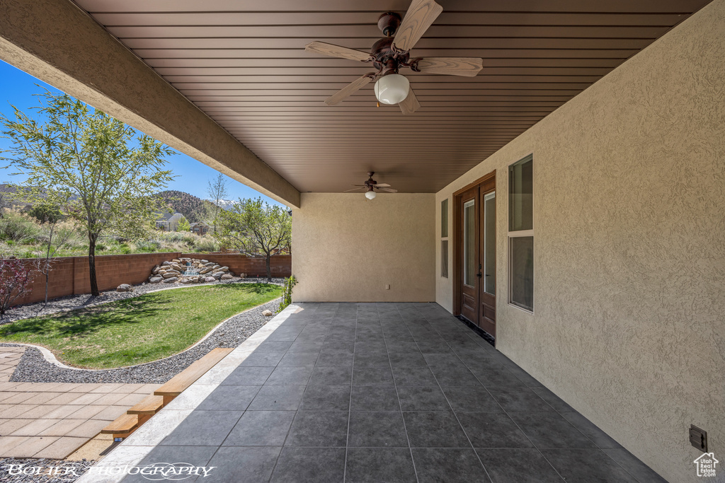 View of patio with a ceiling fan and a fenced backyard