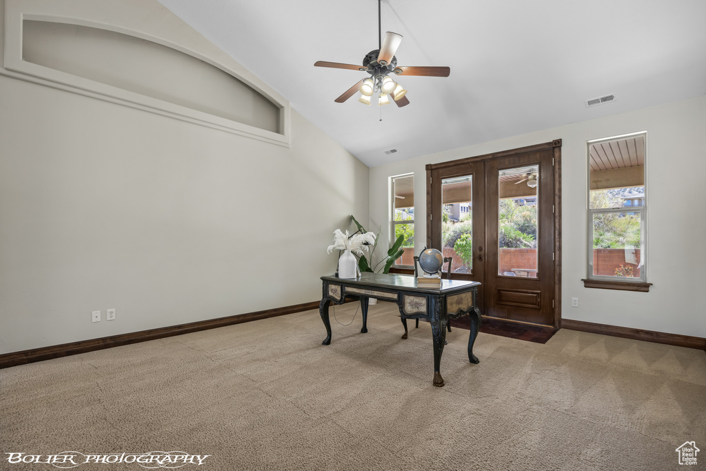 Home office featuring a healthy amount of sunlight, baseboards, ceiling fan, and carpet