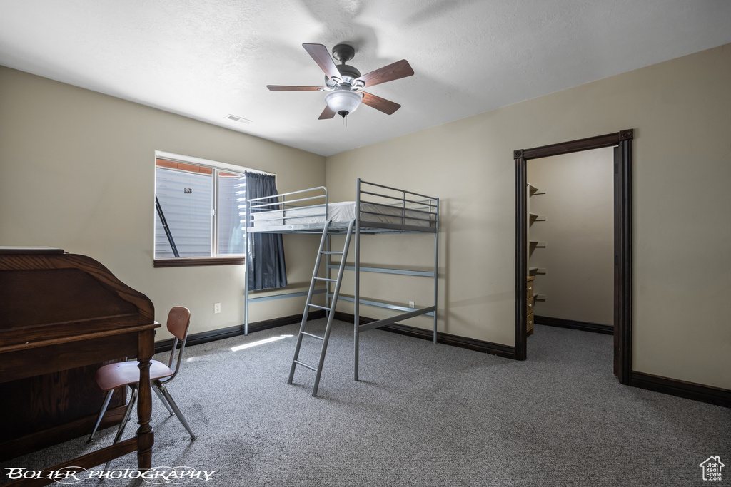 Bedroom featuring baseboards, a ceiling fan, carpet flooring, and visible vents