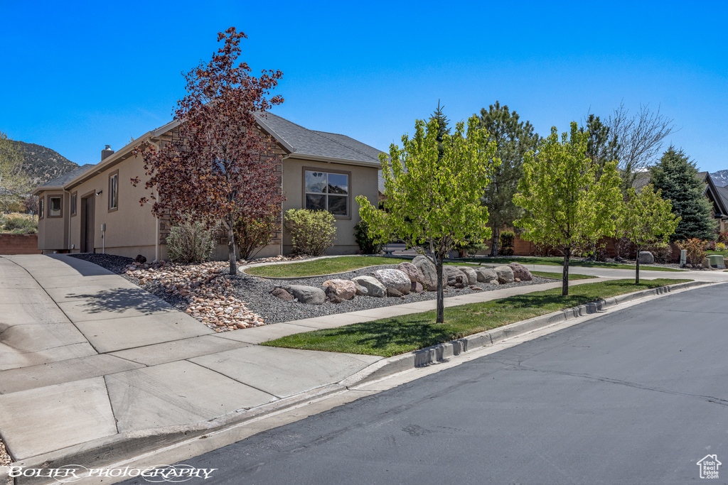 Obstructed view of property featuring stucco siding