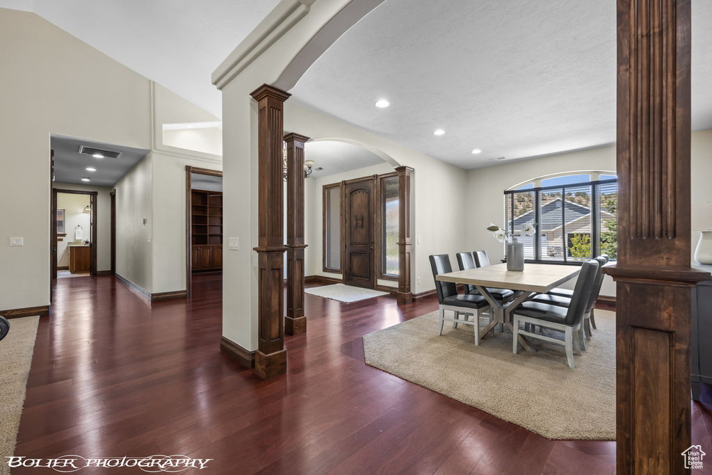 Dining room with visible vents, decorative columns, wood finished floors, recessed lighting, and arched walkways