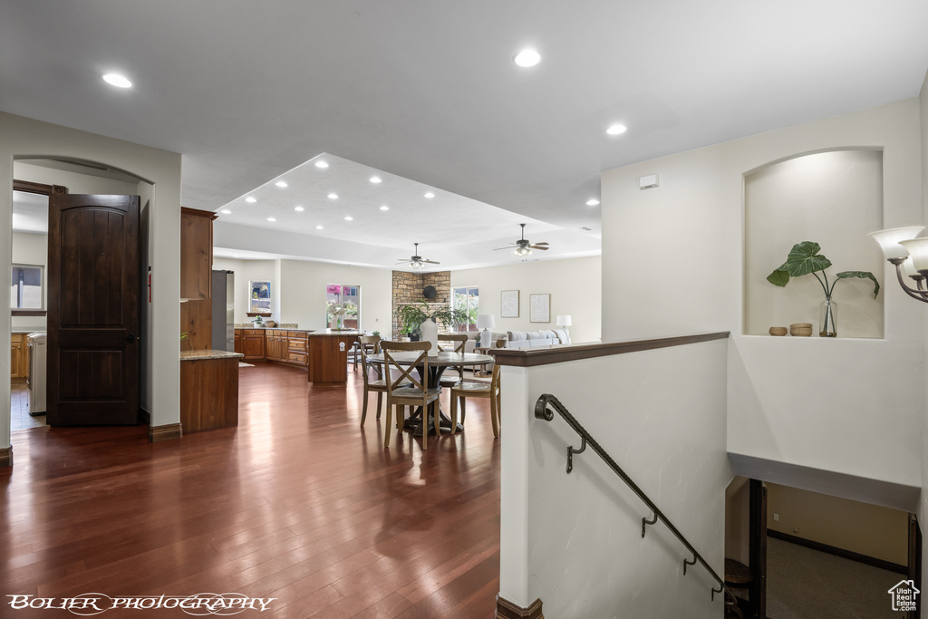 Interior space with recessed lighting, arched walkways, dark wood finished floors, and a ceiling fan