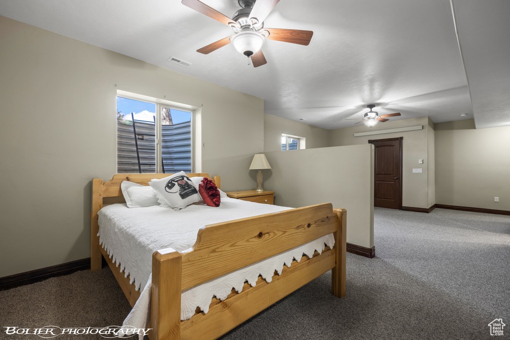 Bedroom with multiple windows, light carpet, and visible vents