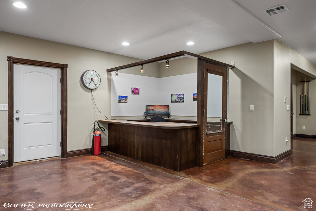 Interior space with recessed lighting, baseboards, visible vents, and finished concrete floors
