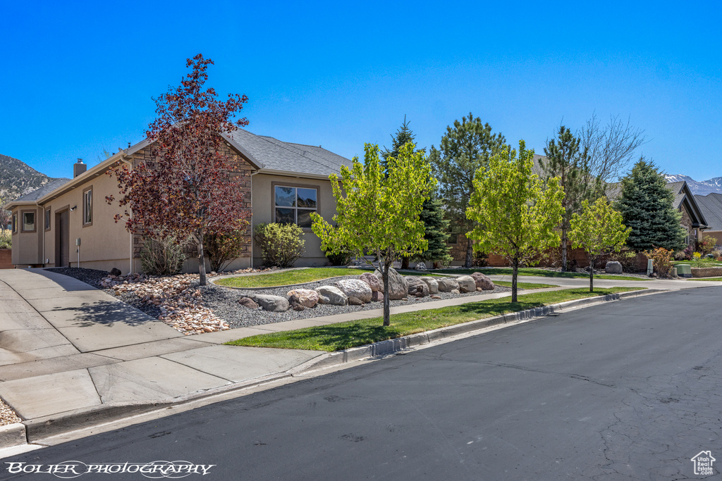 View of front of home with a mountain view and stucco siding