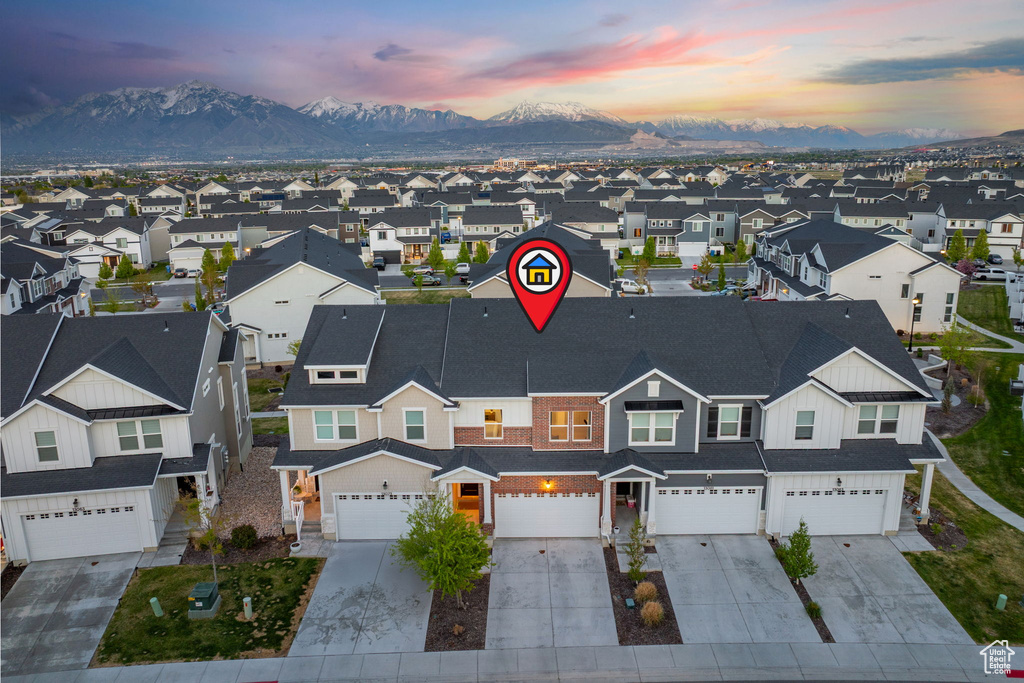 Aerial view at dusk featuring a residential view and a mountain view