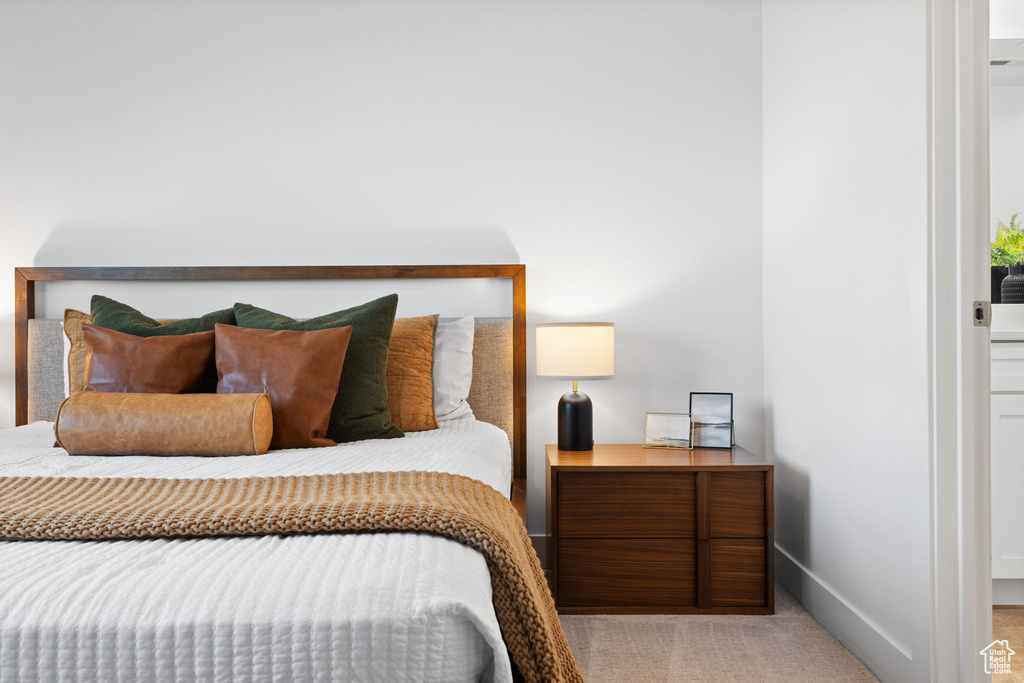 Bedroom featuring light colored carpet and baseboards