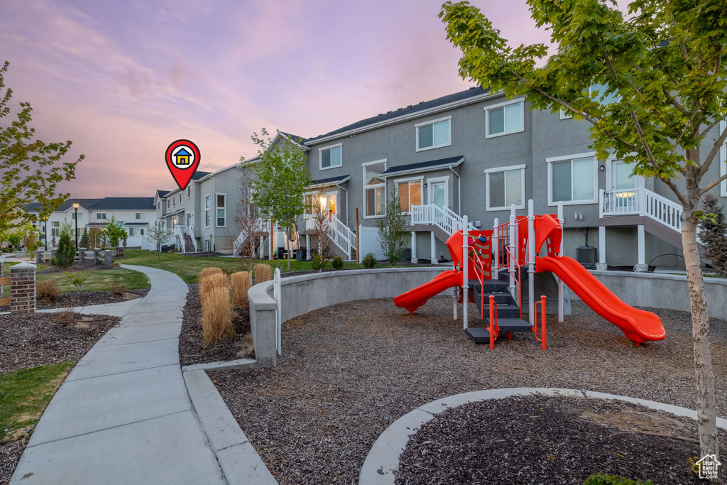 Playground at dusk featuring a residential view and playground community