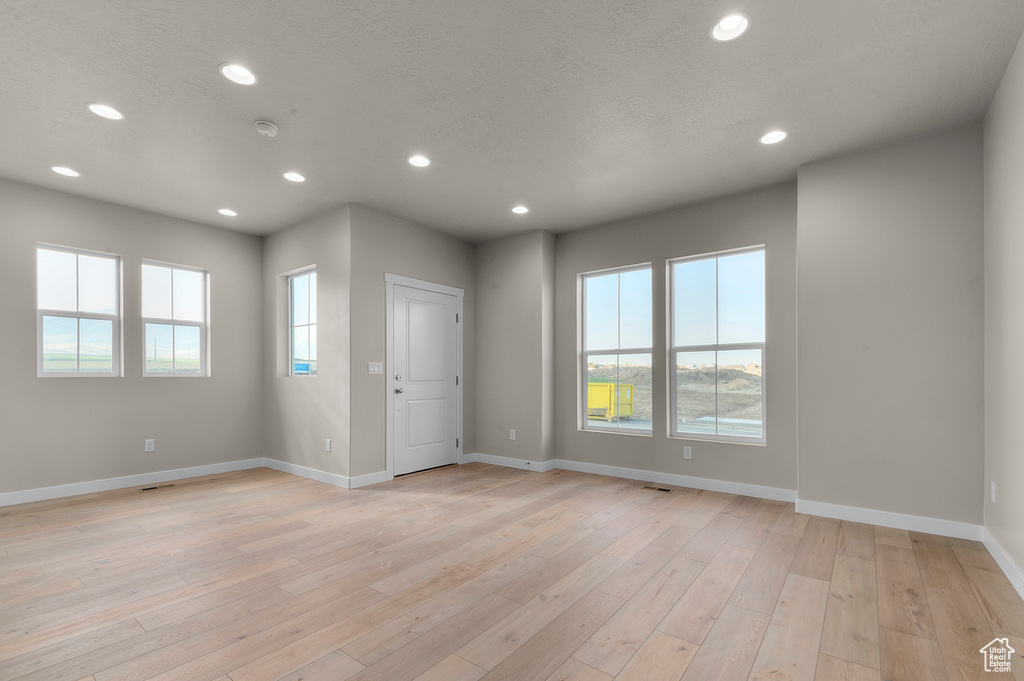 Spare room with recessed lighting, baseboards, visible vents, and light wood-type flooring