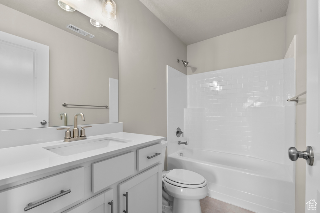 Bathroom featuring shower / bathtub combination, toilet, visible vents, and vanity