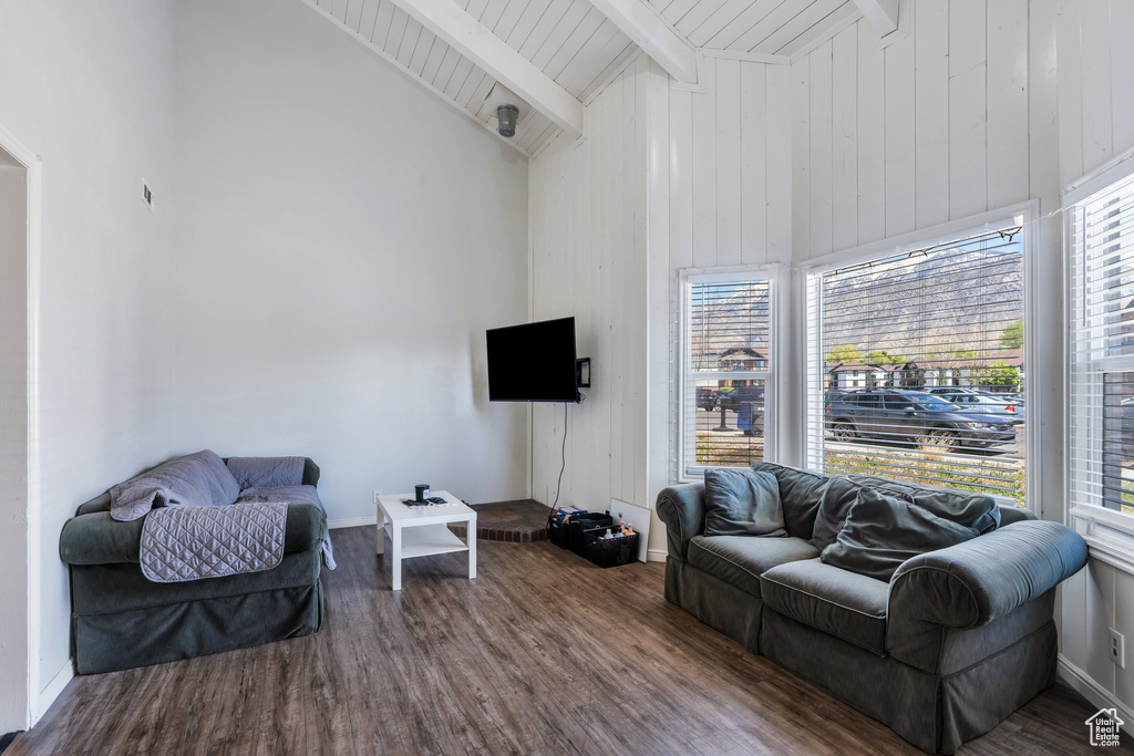 Living room featuring wood ceiling, high vaulted ceiling, beam ceiling, and wood finished floors
