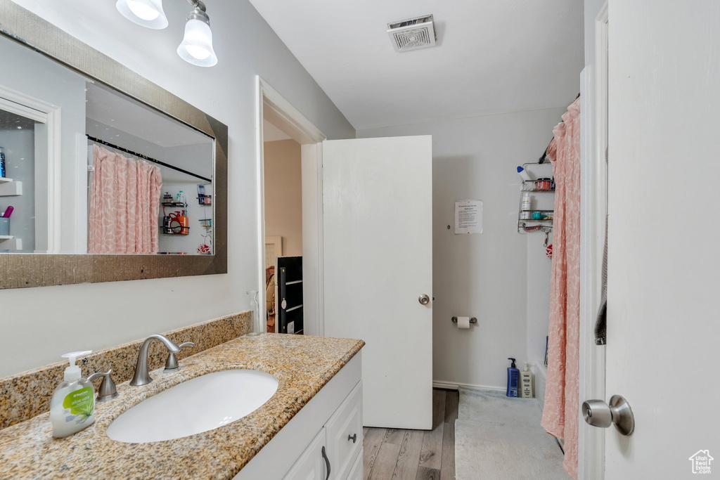 Bathroom with visible vents, wood finished floors, and vanity