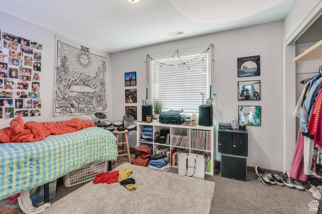 Bedroom with carpet floors and visible vents