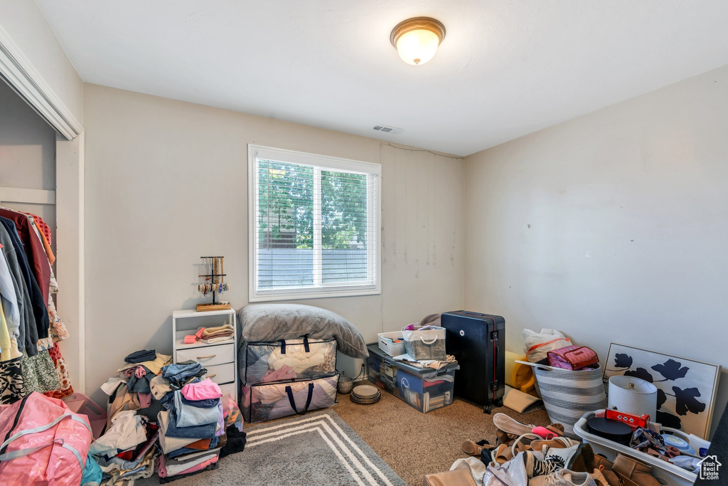 Carpeted bedroom featuring visible vents
