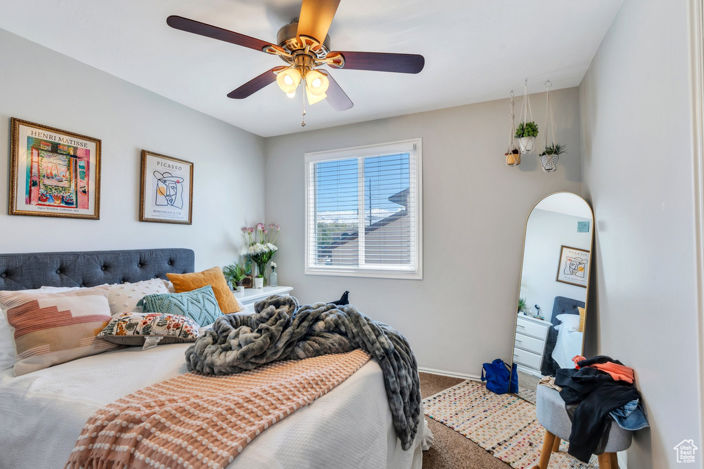 Bedroom with carpet flooring, arched walkways, baseboards, and ceiling fan