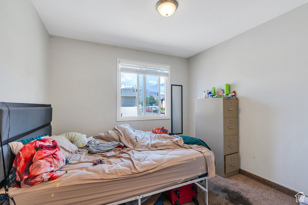 Carpeted bedroom featuring baseboards