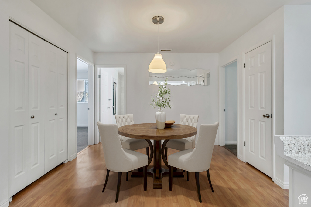 Dining room featuring visible vents and light wood-style floors