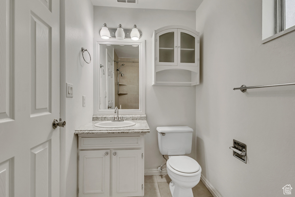 Full bathroom with vanity, toilet, visible vents, walk in shower, and tile patterned flooring