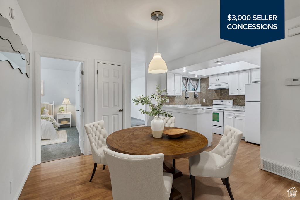 Dining room with light wood finished floors and baseboards