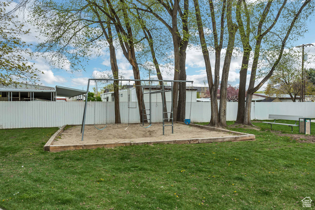 Communal playground with fence and a lawn