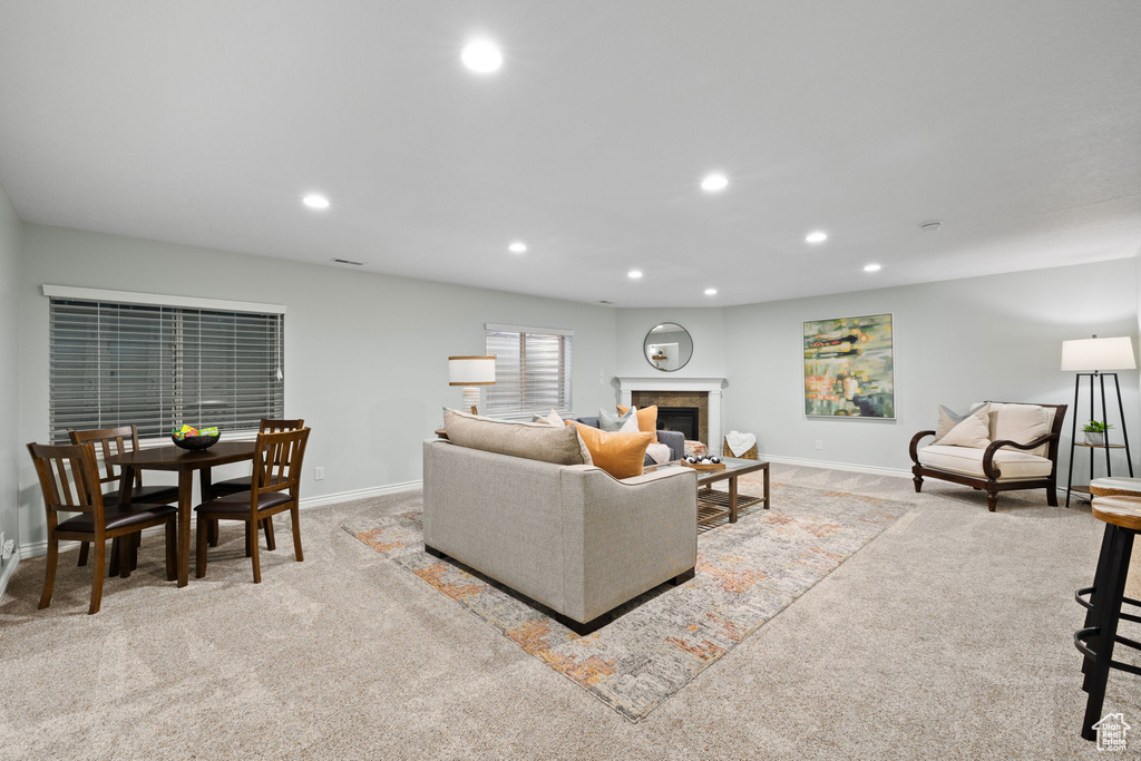 Living room featuring baseboards, recessed lighting, and light colored carpet