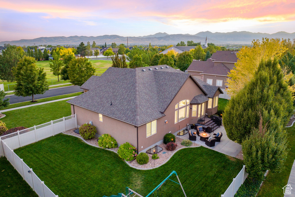 Aerial view at dusk featuring a mountain view