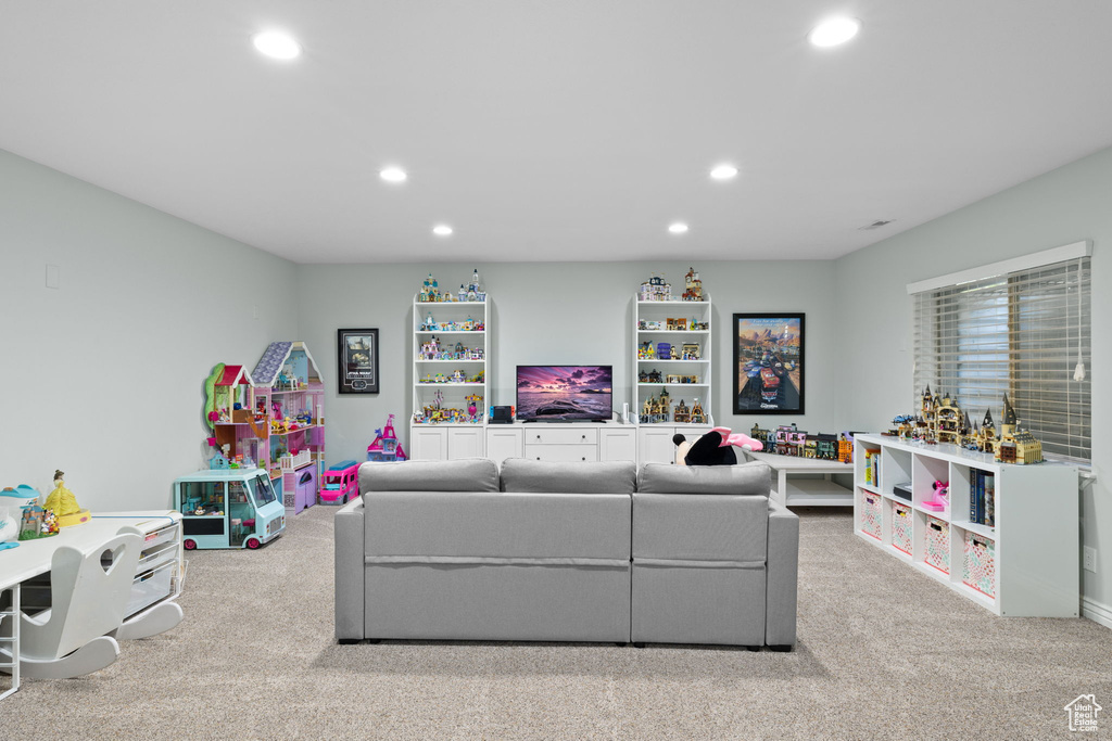 Carpeted living area featuring recessed lighting